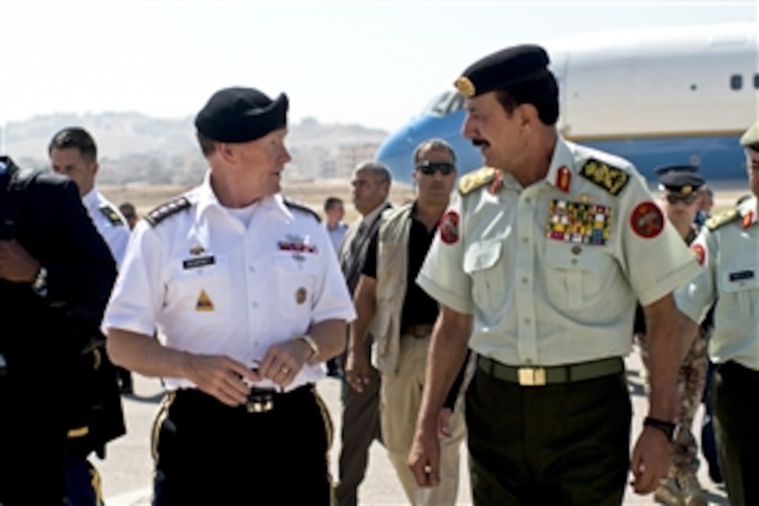 U.S. Army Gen. Martin E. Dempsey, chairman of the Joint Chiefs of Staff, walks with Lt. Gen. Mashal al-Zaben, Jordan's defense chief, after arriving in Amman, Jordan, Aug. 14, 2013. Dempsey is visiting leaders in Jordan and Israel.