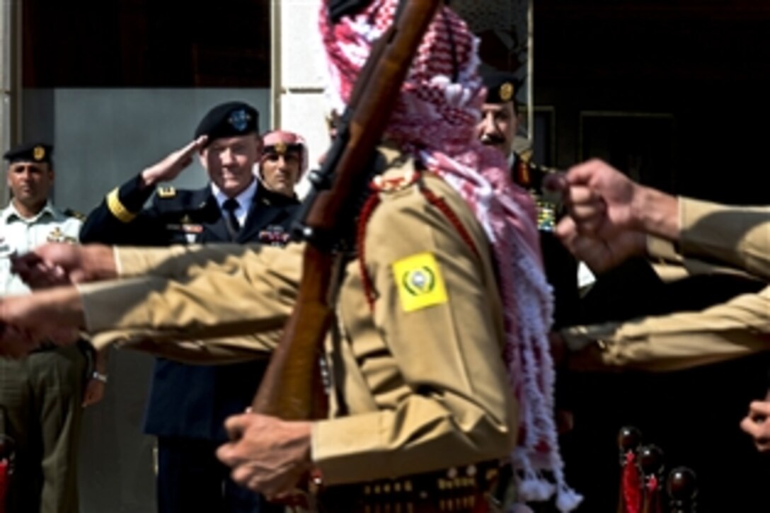 U.S. Army Gen. Martin E. Dempsey, chairman of the Joint Chiefs of Staff, salutes members of the Jordanian honor guard after a pass-and-review ceremony in Amman, Jordan, Aug. 14, 2013. Dempsey is visiting leaders in Jordan and Israel.