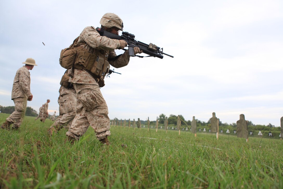 Cpl. Timothy Zajac of Company G, 2nd Battalion, 24th Marine Regiment, advances on his target while firing at Camp Atterbury, Ind., Aug. 10. Part of their regular rifle qualification includes turning, aiming, moving and firing on a close-range target, reinforcing combat marksmanship techniques. (U.S. Marine Corps photo by Lance Cpl. Tiffany Edwards)