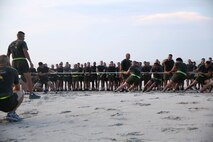 Marines with 2nd Maintenance Battalion, Combat Logistics Regiment 25, 2nd Marine Logistics Group participate in a tug-of-war competition following a three mile run down Onslow Beach aboard Camp Lejeune, N.C., Aug. 14, 2013. The event increased camaraderie and allowed the Marines to have fun while working out. (U.S. Marine Corps photo by Lance Cpl. Shawn Valosin)