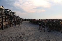 Lt. Col. Craig Clemans (left), the commanding officer of 2nd Maintenance Battalion, Combat Logistics Regiment 25, 2nd Marine Logistics Group, addresses his Marines after a morning physical training session aboard Camp Lejeune, N.C., Aug. 14, 2013. The battalion ran three miles on Onslow Beach and held a tug-of-war competition. (U.S. Marine Corps photo by Lance Cpl. Shawn Valosin)