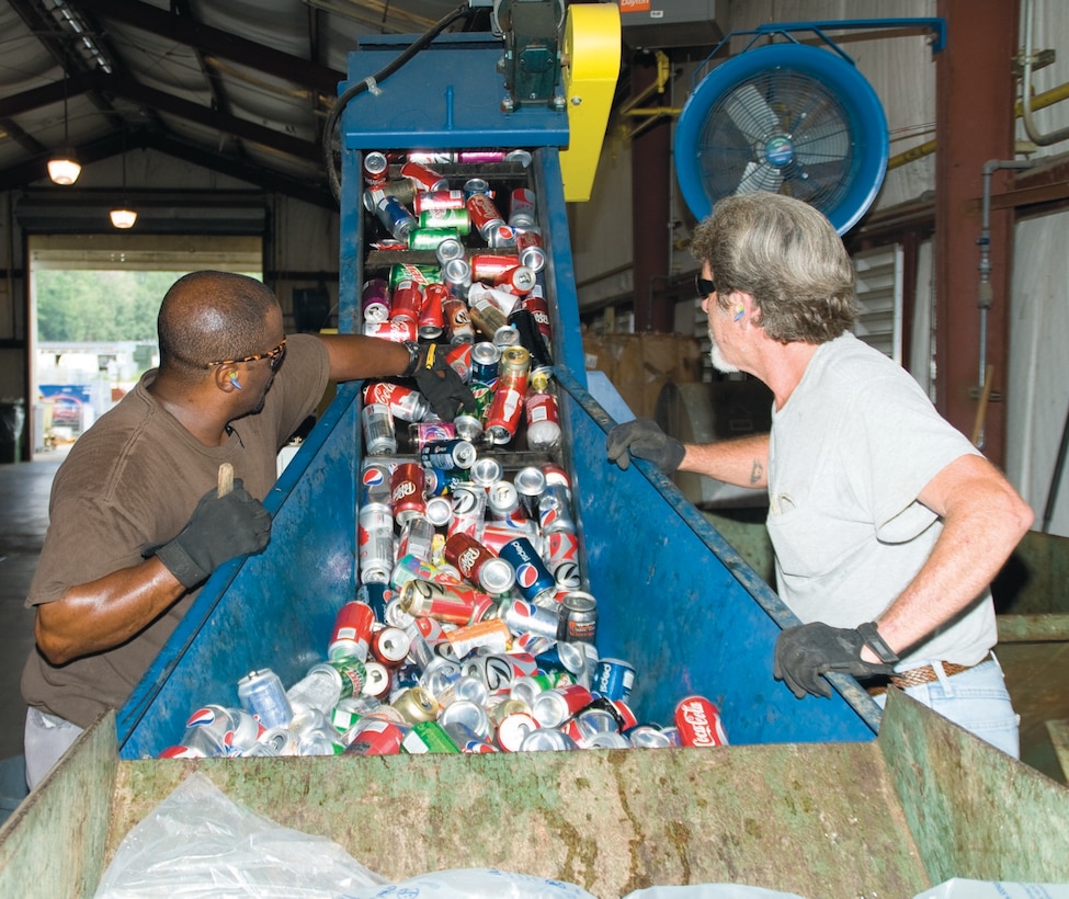 Greg Thorne, left, and Rocky Goddard, both forklift operators, Environmental?Branch, Installation and Environment Division, Marine Corps Logistics Base Albany, recycle cans Aug. 1 at the Base Recycling Center.