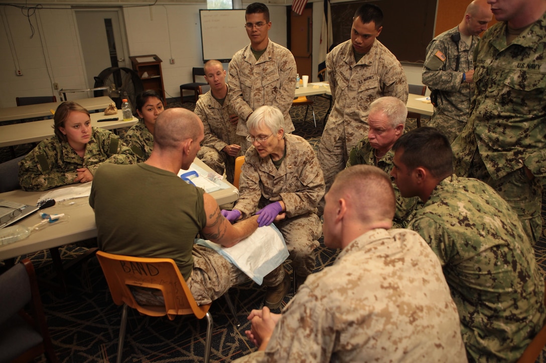 Capt. Kathleen A. McGowan, officer-in-charge of the Innovation Readiness Training, Joint Task-Force Summit West Virginia medical department, explains and demonstrates how to prepare and execute intravenous therapy as part of one of IRT Summit’s daily “Buddy Aid” medical training courses, at Mount Hope, W. Va., Aug. 5. IRT Summit is a Marine-led training event with support from the Navy, Army Reserve and Army National Guard. It provides real-world training opportunities for service members and units to prepare them for their wartime missions while supporting the needs of America’s underserved communities. 