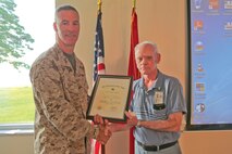 Col. Timothy M. Salmon, Marine Corps Air Station New River commanding officer presents an award for more than 50 years of service to Terry Trenchard, air station supply technician, during a civilian breakfast and award ceremony at the Officers Club, Aug. 7. 