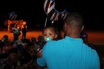 Annette Rall greets her husband, Cpl. Ethan Rall, upon his return from a seven-month deployment to Afghanistan. She then introduced Rall to their younest child, who was born during the deployment.