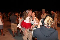 Annette Rall greets her husband, Cpl. Ethan Rall, upon his return from a seven-month long deployment to Afghanistan. She then introduced Rall to their youngest child, who was born during the deployment.
