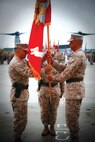 Col. Christopher C. Seymour, right, hands over the Marine Aircraft Group 26 colors to Col. John C. Vara during a change of command ceremony at the Marine Medium Tiltrotor Training Squadron 204 flight line aboard Marine Corps Air Station New River, Aug. 2.