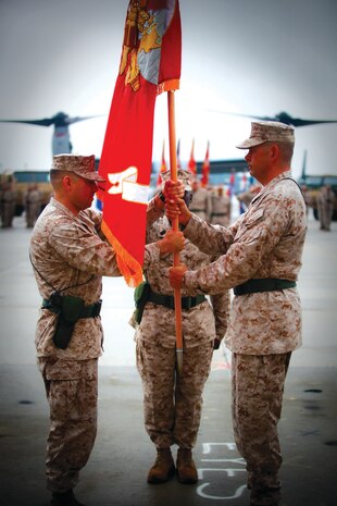 Col. Christopher C. Seymour, right, hands over the Marine Aircraft Group 26 colors to Col. John C. Vara during a change of command ceremony at the Marine Medium Tiltrotor Training Squadron 204 flight line aboard Marine Corps Air Station New River, Aug. 2.