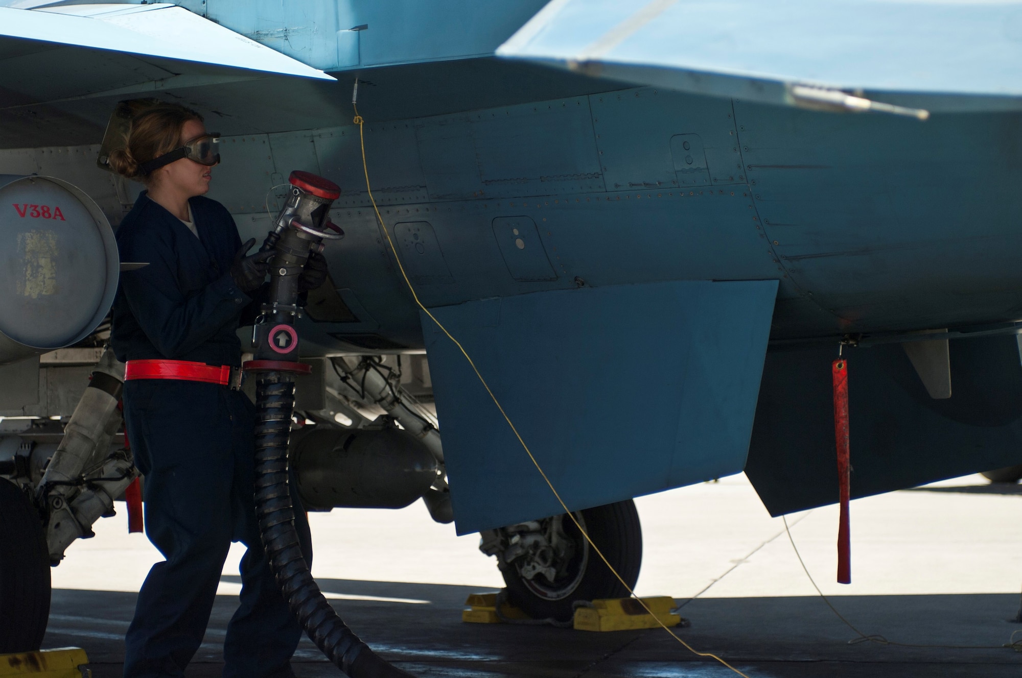 Staff Sgt. Chelsea Mays disconnects a fuel hose as part of preflight preparations for a 64th Aggressor Squadron F-16 Fighting Falcon Aug. 13, 2013, at Nellis Air Force Base, Nev. It is the crew chief's responsibility to ensure the aircraft is properly refueled before each training mission.  Mays is a F-16 crew chief assigned to the 926th Aircraft Maintenance Squadron. (U.S. Air Force photo/Airman 1st Class Joshua Kleinholz)

