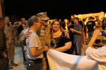 A family embraces their Marine upon his return from a seven-month long deployment to Afghanistan, Aug. 10.