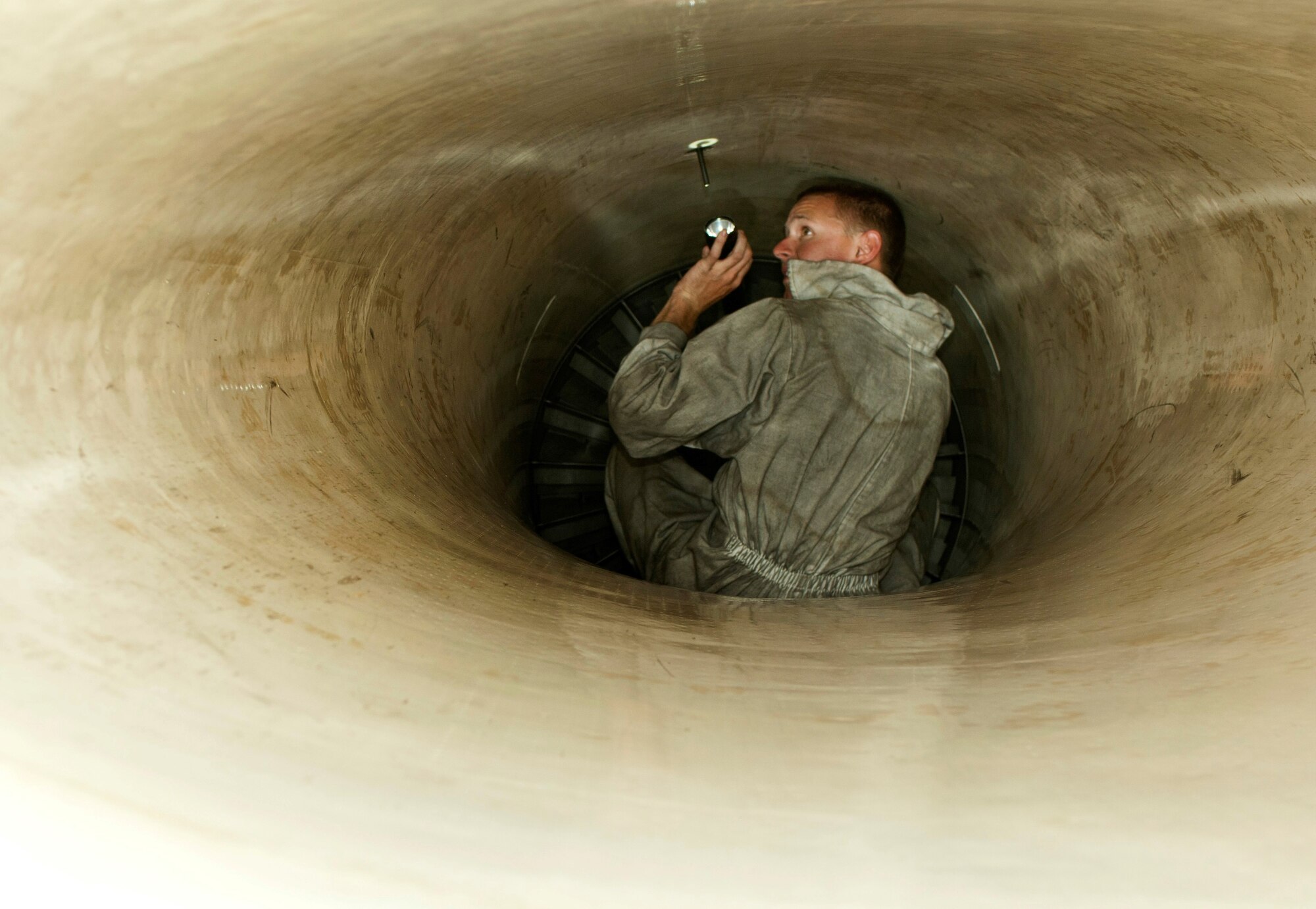 Senior Airman Zachary Gant inspects the intake of a 64th Aggressor Squadron  F-16 Fighting Falcon as part of a preflight inspection Aug. 13, 2013, at Nellis Air Force Base, Nev. The crew chief must check the intake blades for any cracks or foreign object debris to ensure a safe flight. Gant is a crew chief assigned to the 57th Aircraft Maintenance Squadron. (U.S. Air Force photo/Airman 1st Class Joshua Kleinholz)