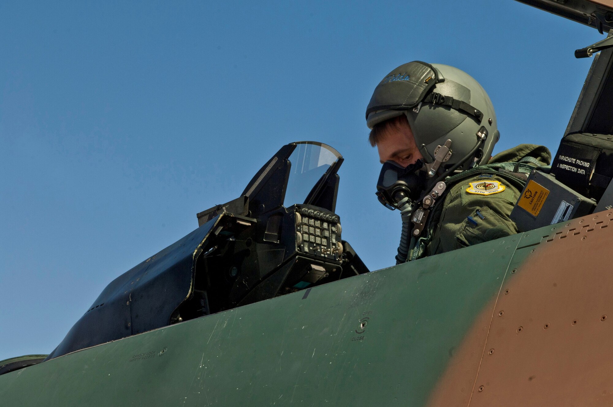 Capt. Steven Wilhoit goes through a preflight checklist before a training flight Aug. 13, 2013, at Nellis Air Force Base, Nev. Aggressor pilots are trained in the use of adversary tactics to better prepare U.S. and allied pilots for possible air-to-air conflict. Wilhoit is an F-16 Fighting Falcon pilot assigned to the 64th Aggressor Squadron. (U.S. Air Force photo/Airman 1st Class Joshua Kleinholz)

