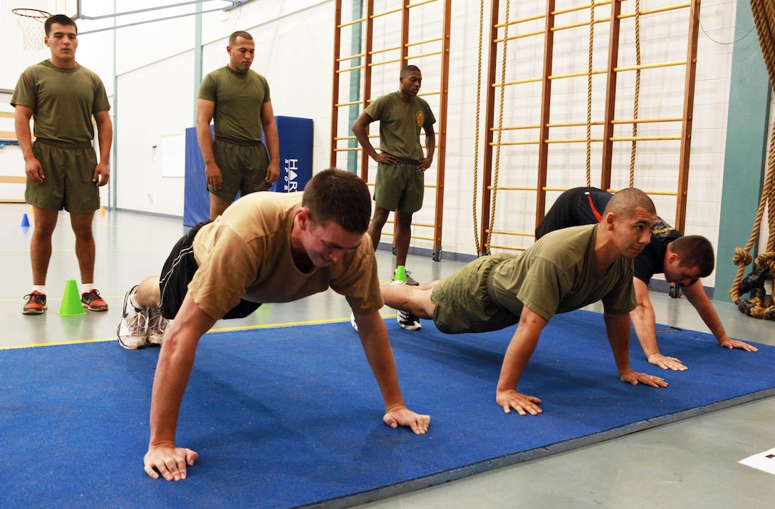 Marines with Marine Rotational Force - Darwin and Australian soldiers conduct a maximum set of pushups in two minutes as part of a Combat Fitness Leadership Course Barrier Test at the Northern Gym, here, July 30. This was one of seven different exercises participants had to complete. The top two Marine performers in the barrier test will attend the month-long CFLC.
