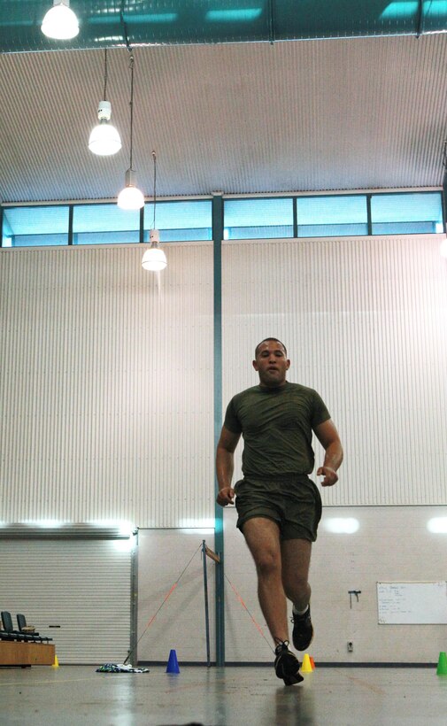 Cpl. Luis Vasquez, automotive mechanic, Lima Company, 3rd Battalion, 3rd Marine Regiment, Marine Rotational Force - Darwin, runs an Illinois Shuttle, a series of sprints to be completed in 18 seconds or less, as part of a Combat Fitness Leadership Course Barrier Test at the Northern Gym, here, July 30. This was one of seven different exercises participants had to complete. The top two Marine performers in the barrier test will attend the month-long CFLC.