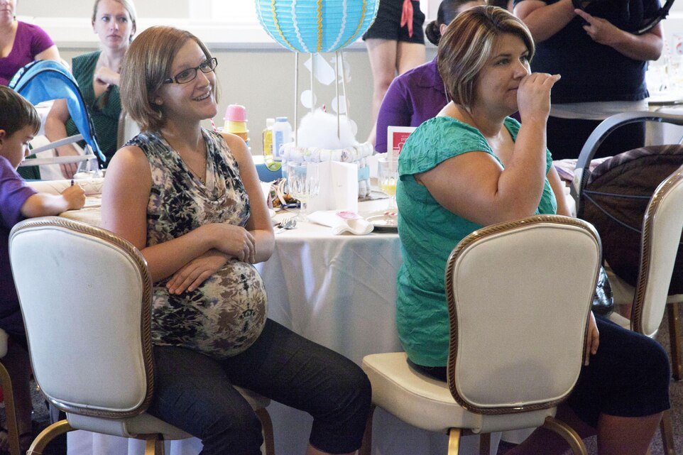 Expectant moms receive comforting words of support from LeAnn Morrissey, chief shower officer of Operation Shower, during a baby shower at the Ball Center aboard Marine Corps Base Camp Lejeune, Aug. 6. Find us on Google + (http://gplus.to/camp.lejeune)Follow us on Twitter (http://twitter.com/camp_lejeune)Like us on Facebook (http://www.facebook.com/camp.lejeune) 