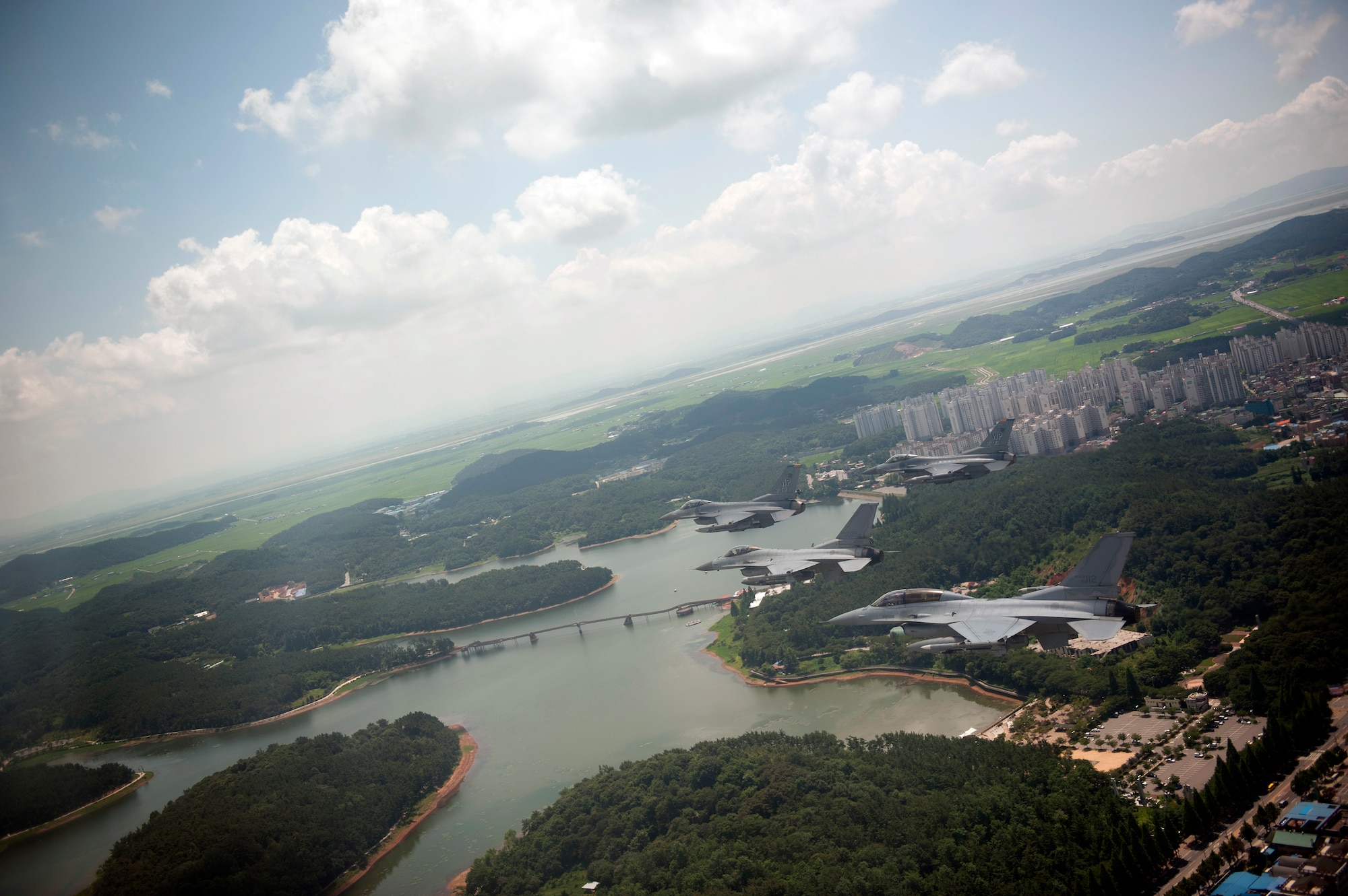 GUNSAN, Republic of Korea – Colonel S. Clinton Hinote, 8th Fighter Wing commander, leads an F-16 friendship flight with Republic of Korea air force Col. Min-Oh Seo, 38th Fighter Group commander, over Eunpa Lake, Aug. 14, 2013. The flight provided the U.S. Air Force and ROK air force a chance to build camaraderie while keeping their skills current. (U.S. Air Force photo by Senior Airman Clayton Lenhardt/Released)