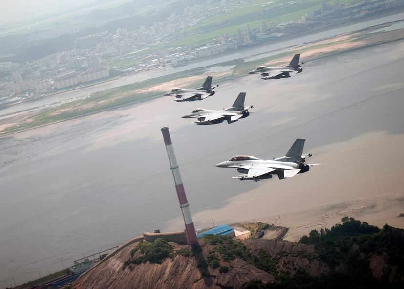 GUNSAN, Republic of Korea – Colonel S. Clinton Hinote, 8th Fighter Wing commander, leads a friendship flight with Republic of Korea air force Col. Min-Oh Seo, 38th Fighter Group commander, past LS Refinery and Factory, Aug. 14, 2013. The two commanders participated in a training mission that allowed U.S. and ROK air force pilots to develop improved communication and coordination. (U.S. Air Force photo by Senior Airman Clayton Lenhardt/Released)