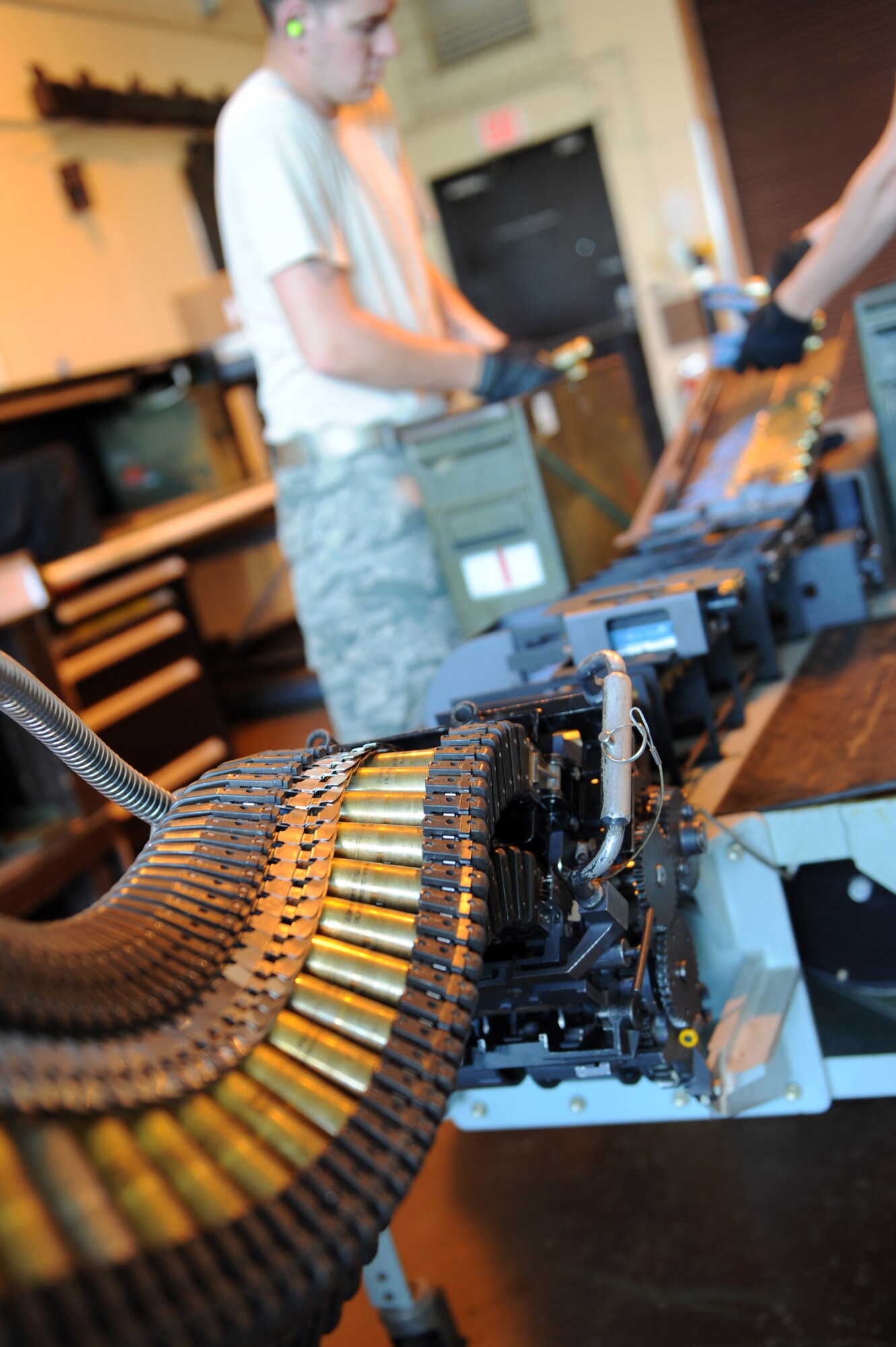 U.S. Air Force Senior Airman Ben Staples, 35th Maintenance Squadron munitions crew chief, loads 20mm rounds on to a Universal Ammunition Loading System at Misawa Air Base, Japan, Aug. 14, 2013. Munitions Airmen provide and prepare ammo for gun systems on F-16 Fighting Falcons.  (U.S. Air Force photo by Senior Airman Kia Atkins)