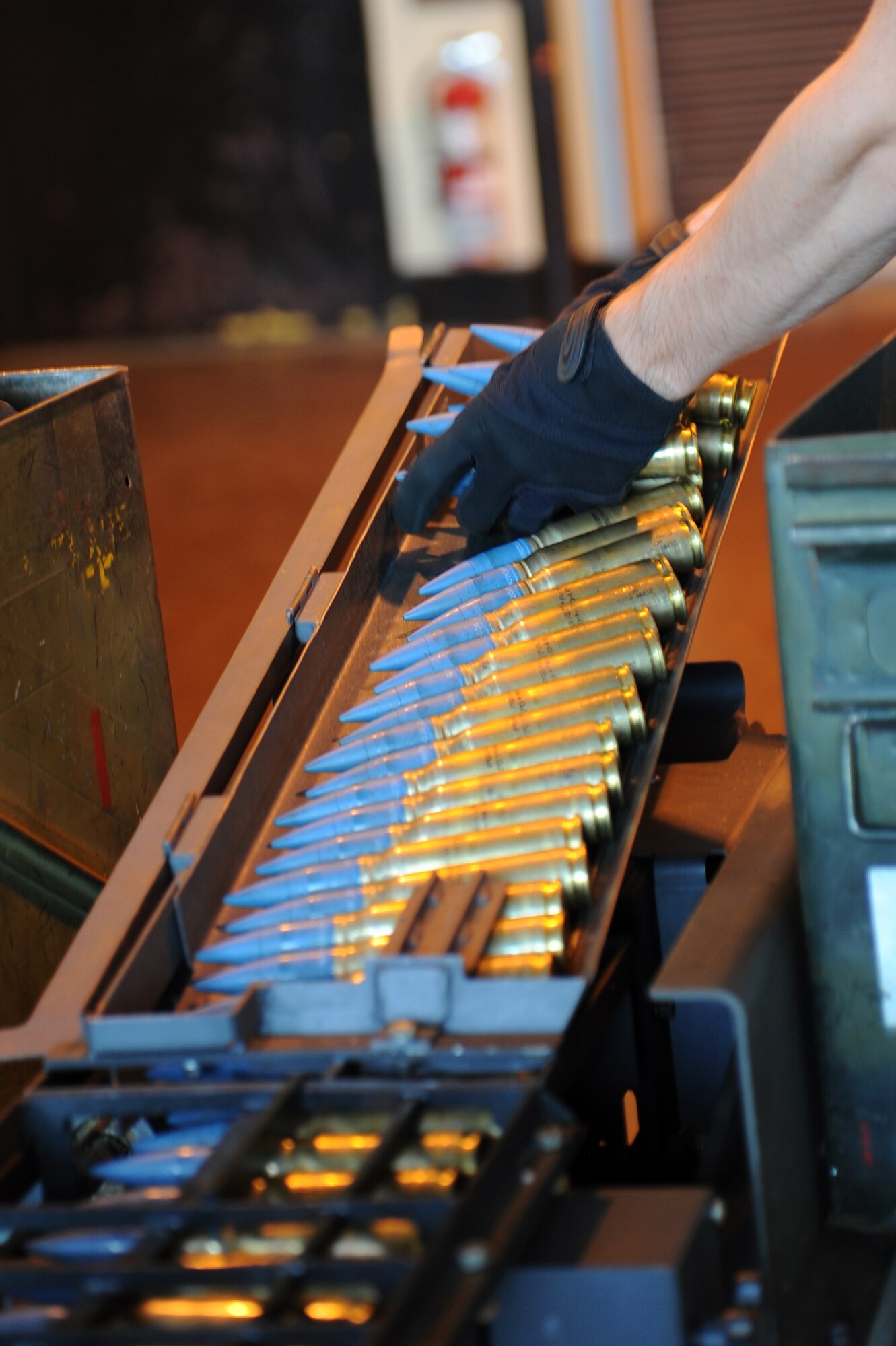 U.S. Air Force Airman 1st Class Tyler Peterson, 35th Maintenance Squadron munitions crew member, loads 20mm rounds on to a Universal Ammunition Loading System at Misawa Air Base, Japan, Aug. 14, 2013. F-16 Fighting Falcons use these munitions with the M61 gun system during live-fire training. (U.S. Air Force photo by Senior Airman Kia Atkins)