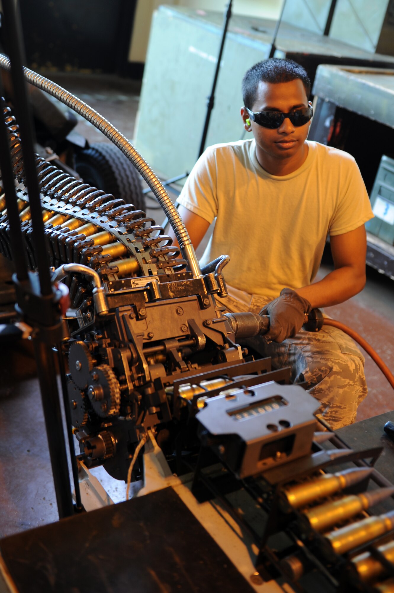 U.S. Air Force Airman 1st Class Junu Johnny, 35th Maintenance Squadron munitions crew member, loads 20mm rounds on to a Universal Ammunition Loading System at Misawa Air Base, Japan, Aug. 14, 2013. The 20mm round is used for air-to-air and air-to-ground targets in the M61 gun system for F-16 Fighting Falcons. (U.S. Air Force photo by Senior Airman Kia Atkins)