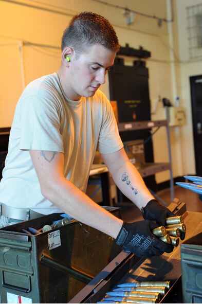 U.S. Air Force Senior Airman Ben Staples, 35th Maintenance Squadron munitions crew chief, loads 20mm rounds on to a Universal Ammunition Loading System at Misawa Air Base, Japan, Aug. 14, 2013. The UALS are used to transport and load ammunition onto an aircraft. (U.S. Air Force photo by Senior Airman Kia Atkins)