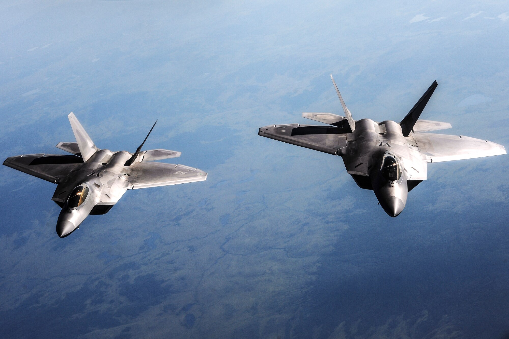 Two U.S. Air Force F-22 Raptors from Joint Base Elmendorf-Richardson, Alaska, fly behind a KC-135 Stratotanker from Kadena Air Base, Japan, over the Joint Pacific Alaska Range Complex during RED FLAG-Alaska 13-3 Aug. 14, 2013. The F-22 is a twin-engine fighter aircraft designed primarily for air superiority, but also has ground attack and electronic warfare capabilities. (U.S. Air Force photo by Senior Airman Zachary Perras/Released)