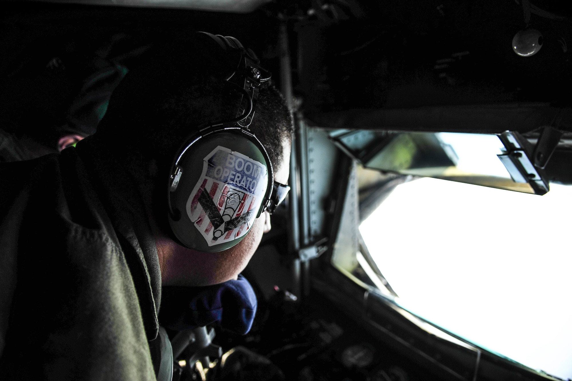 Tech. Sgt. Roger Braun, 909th Air Refueling Squadron boom operator, Kadena Air Base, Japan, prepares to lower the boom of a KC-135 Stratotanker over the Joint Pacific Alaska Range Complex during RED FLAG- Alaska 13-3 Aug. 14, 2013. Nearly all internal fuel, a maximum transfer load of approximately 200,000 pounds, can be pumped through the aircraft’s boom, a rigid, telescoping tube equipped with movable flight control surfaces that an operator controls. (U.S. Air Force photo by Senior Airman Zachary Perras/Released)