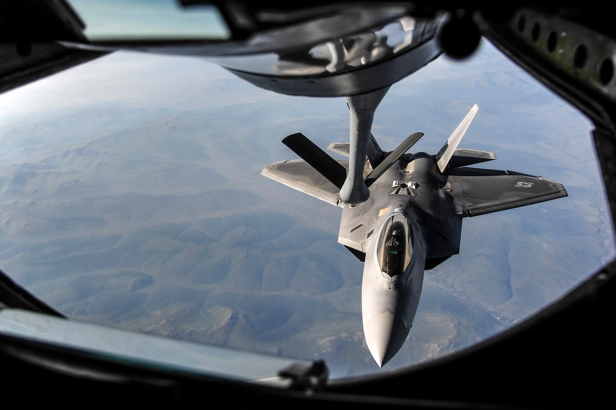 A U.S. Air Force F-22 Raptor from Joint Base Elmendorf-Richardson, Alaska, approaches a KC-135 Stratotanker from Kadena Air Base, Japan, to be refueled over the Joint Pacific Alaska Range Complex during RED FLAG-Alaska 13-3 Aug. 14, 2013. RF-A provides participants the unique opportunity to integrate various forces in a simulated combat environment. (U.S. Air Force photo by Senior Airman Zachary Perras/Released)