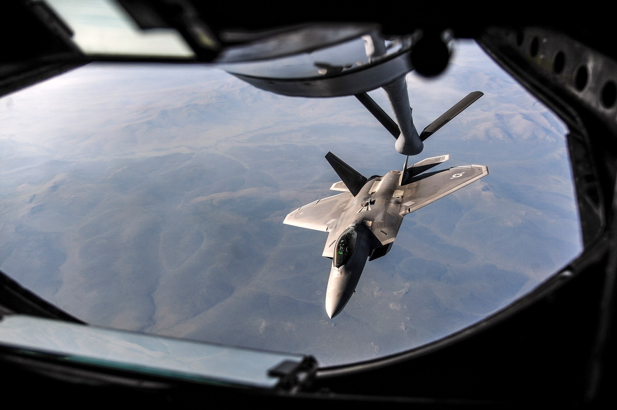 A U.S. Air Force F-22 Raptor from Joint Base Elmendorf-Richardson, Alaska, breaks away after being refueled by a KC-135 Stratotanker from Kadena Air Base, Japan, over the Joint Pacific Alaska Range Complex during RED FLAG-Alaska 13-3 Aug. 14, 2013. RF-A is a Pacific Air Forces-sponsored field training exercise designed to increase wartime capabilities in a simulated combat environment. (U.S. Air Force photo by Senior Airman Zachary Perras/Released)