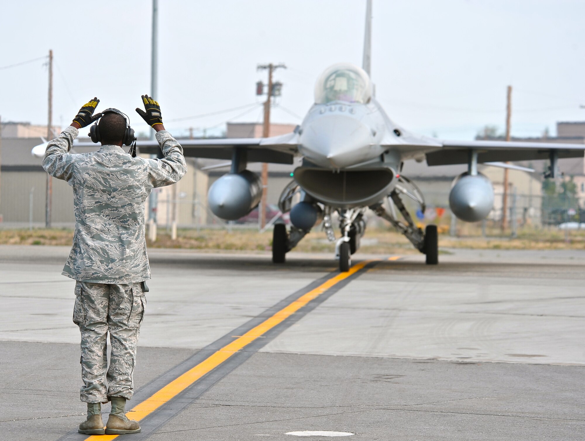 A 100th Fighter Squadron crew chief from Dannelly Field, Ala., communicates instructions to his pilot during RED FLAG-Alaska 13-3 Aug. 12, 2013, Eielson Air Force Base, Alaska. The work completed by crew chiefs provides mission-capable aircraft for pilots so they can provide air support, serving as a vital role in the overall RF-A mission.(U.S. Air Force photo by Staff Sgt. Miguel Lara/Released)