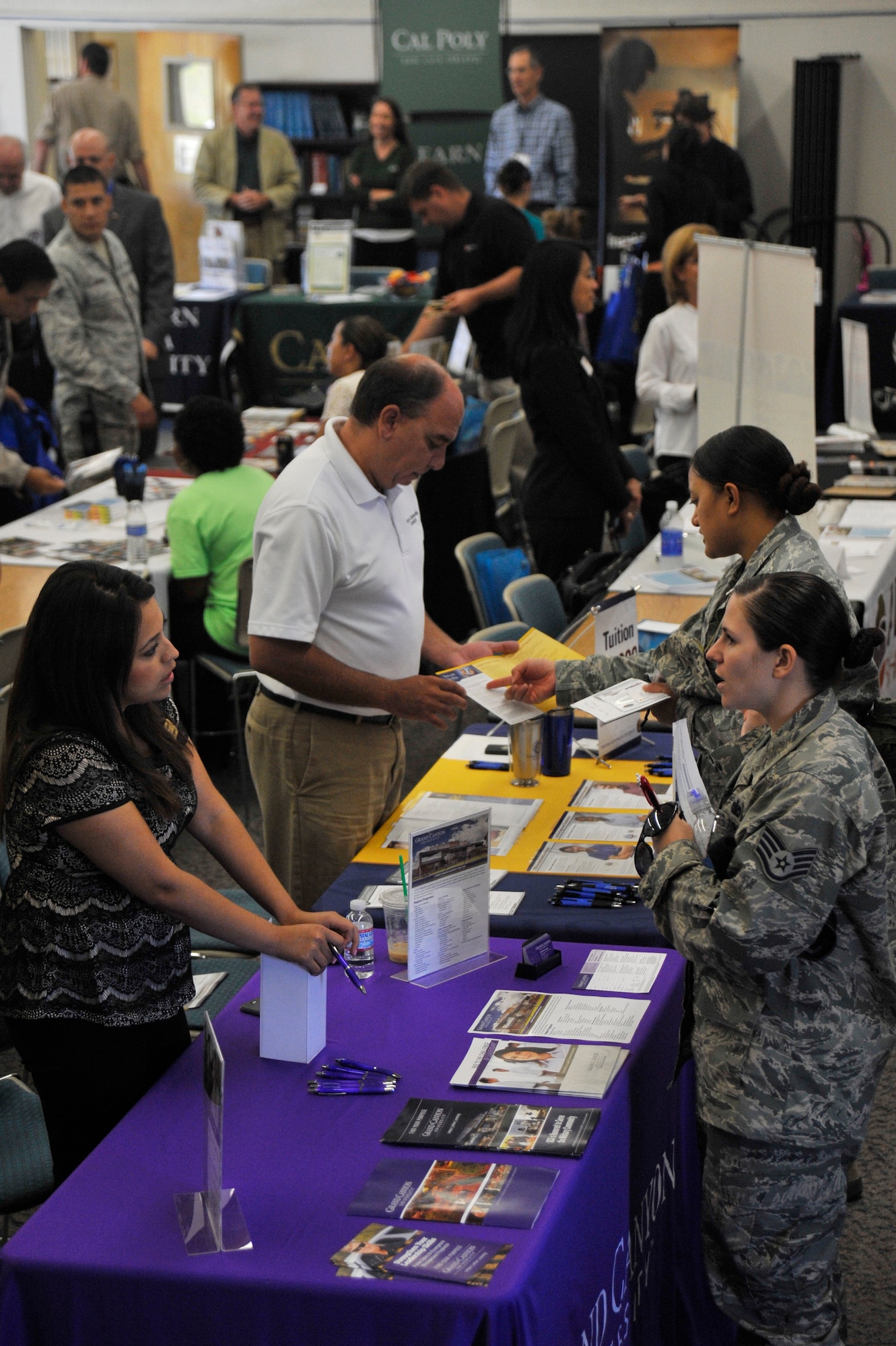 VANDENBERG AIR FORCE BASE, Calif. -- Team V members browse displays and speak with representatives from various universities and educational programs during an education fair here Thursday, August 15, 2013. The 30th Force Support Squadron's Education Center hosts this annual event, inviting educational institutions from across the country to Vandenberg, to provide Team V a one-stop venue to research their educational pursuits. (U.S. Air Force photo/Michael Peterson)