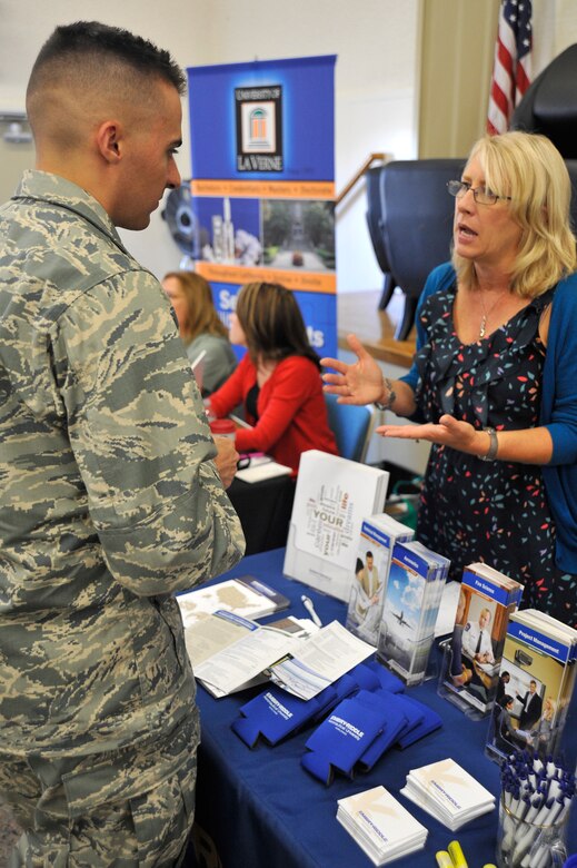 VANDENBERG AIR FORCE BASE, Calif. -- 2nd Lt. Jacob Thomas, 533rd Training Squadron student, listens as a university representative answers his questions during an education fair here Thursday, Aug 15, 2013. Thomas was one of many Airmen who researched educational opportunities during the event, which allowed Vandenberg Airmen to speak with more than 40 different institutions about their educational goals. (U.S. Air Force photo/Michael Peterson)