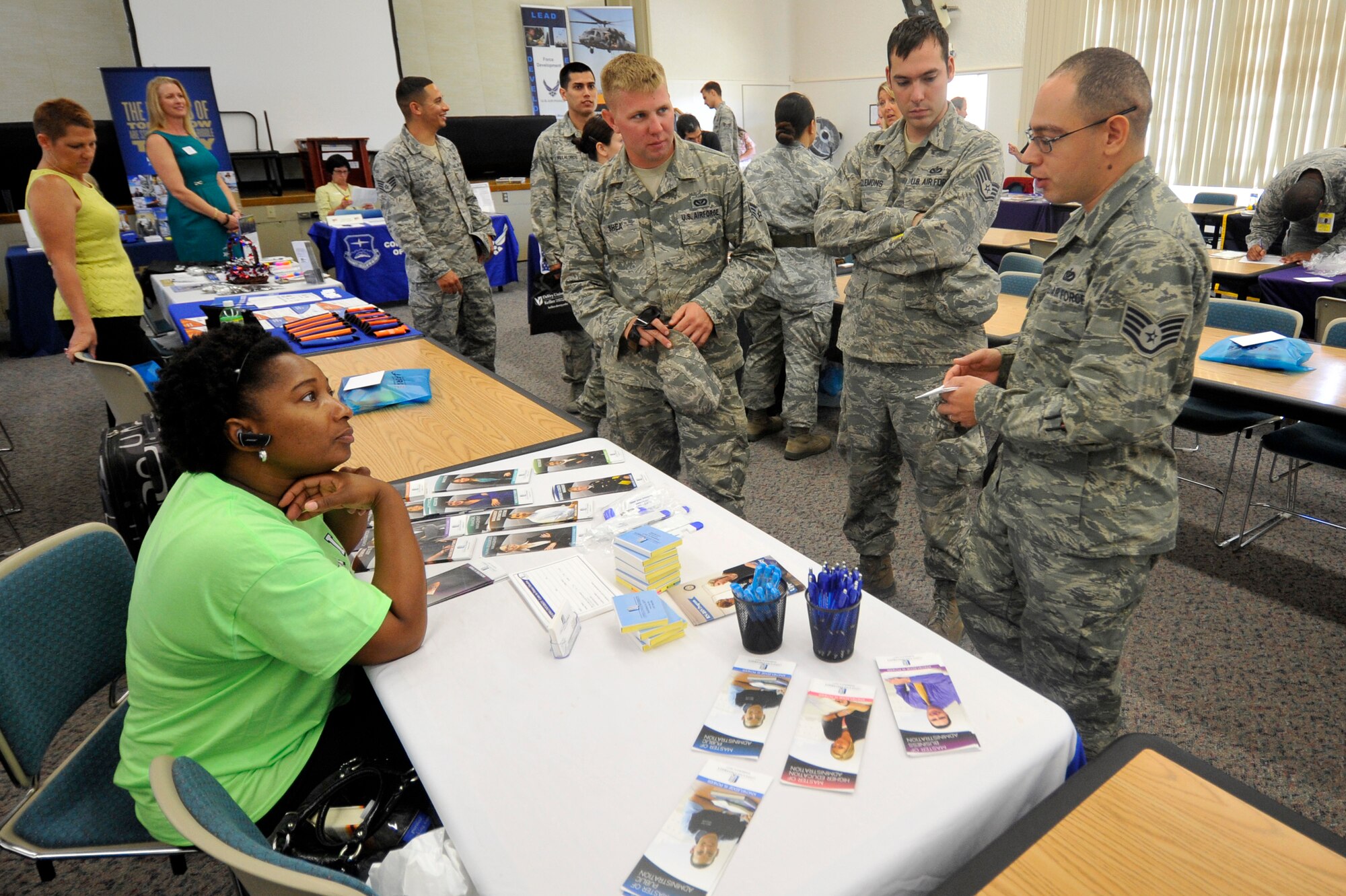 VANDENBERG AIR FORCE BASE, Calif. -- Vandenberg Airmen speak with a university representative about educational opportunities during an education fair here Thursday, August 15, 2013. The 30th Force Support Squadron Education Center hosts this annual event, bringing in representatives from universities and educational programs across the country, to provide Vandenberg airmen a one-stop venue to continue their educational pursuits. (U.S. Air Force photo/Michael Peterson)