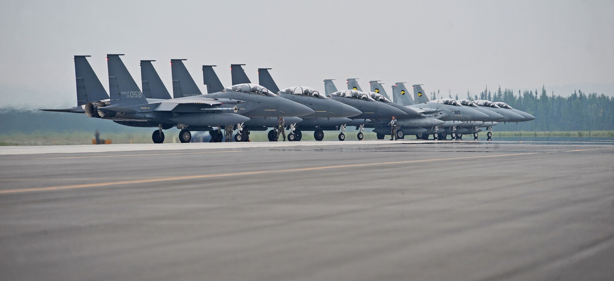 Republic of Korea Air Force F-15K Slam Eagle and Japan Air Self Defense Force F-15 Eagle aircraft park prior to take off during RED FLAG-Alaska 13-3 Aug. 12, 2013, Eielson Air Force Base, Alaska.  RF-A enables joint and international units to sharpen their combat skills by flying simulated combat sorties in a realistic threat environment.  Additionally, the training allows them to exchange tactics, techniques, and procdures and improve interoperability.(U.S. Air Force photo by Staff Sgt. Miguel lara/Released)