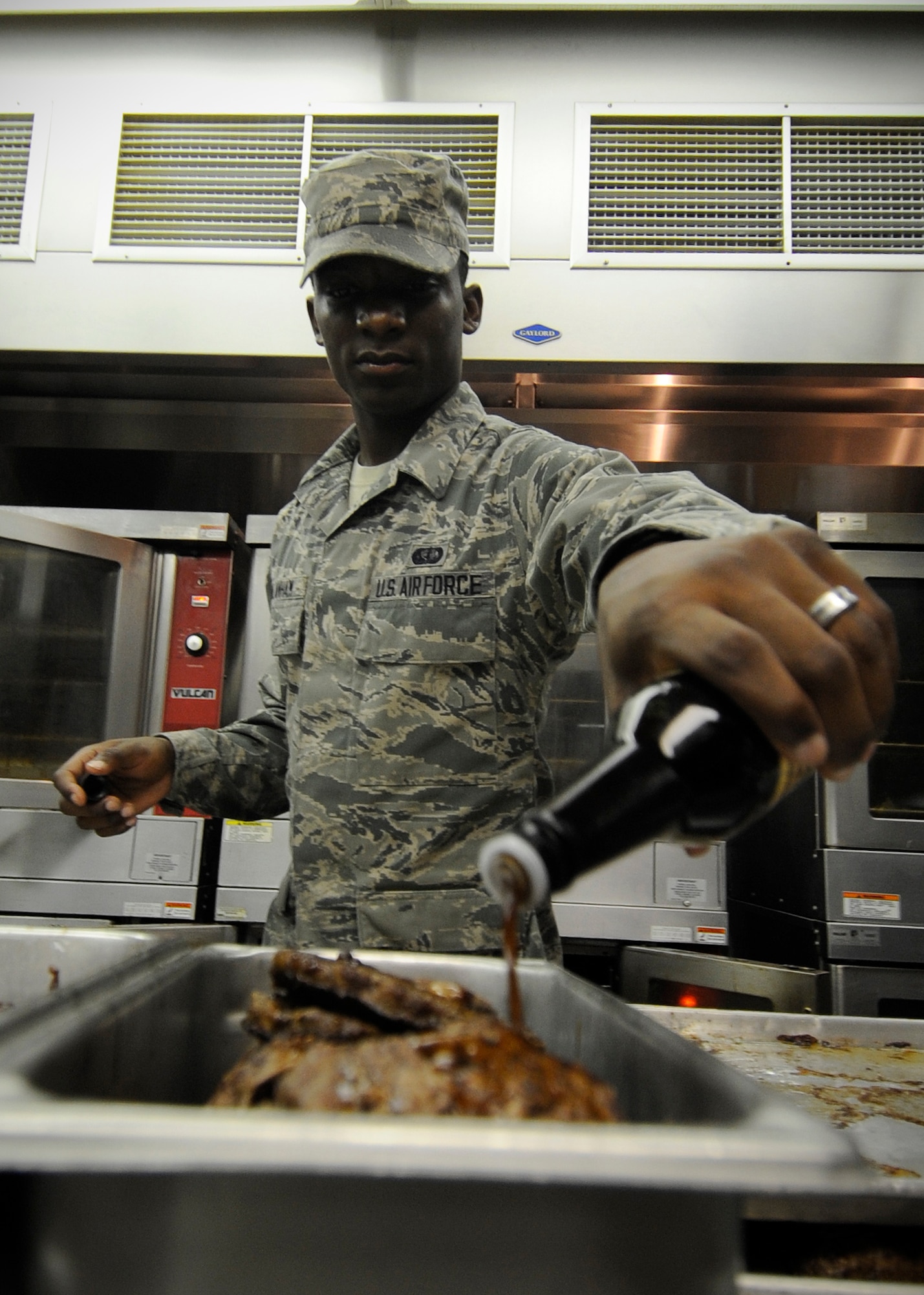 Airman 1st Class Demonta Vanlanham, 354th Force Support Squadron food service apprentice, seasons almost 100 hamburgers prior to the lunch rush during RED FLAG-Alaska 13-3 at the Two Seasons Dining Facility Aug 15, 2013, Eielson Air Force Base, Alaska. Food preparation starts at 4 a.m. each day and the last dirty dish isn’t washed until 2 a.m. the next day. (U.S. Air Force photo by Senior Airman Shawn Nickel/Released)