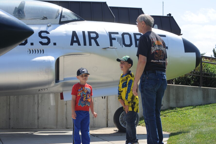 Joe Barlow (far right) along with his son Langdon (middle) and friend of the family Chase tour the Malmstrom Museum Aug 9. Renovations to the museum began July 30 to repair weathering damage that has taken its toll on the museum displays since its opening in the early 1980s. (U.S. Air Force photo/Airman 1st Class Collin Schmidt)