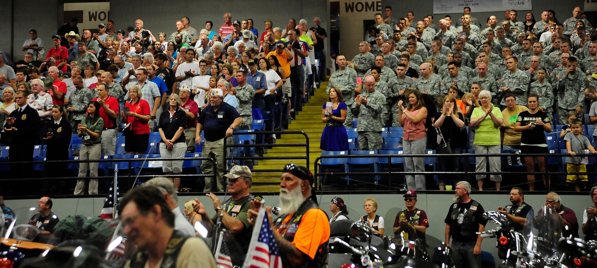 Crowd members applaud the ongoing efforts and sacrifices of Service members during the Military Appreciation Day, Aug. 11, 2013, at the Missouri State Fair in Sedalia, Mo. This year, the ceremony honored the Citizen Soldiers and Airmen of the U.S. National Guard who serve their country while also contributing to their communities. (U.S. Air Force photo by Staff Sgt. Brigitte N. Brantley/Released)
