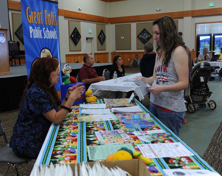 Nichole Travis, spouse of Staff Sgt. Ryan Travis, 341st Civil Engineer Squadron member, right, talks to Stephanie Bautista, Great Falls Public Schools district food supervisor, during the second annual GFPS Information Fair at the Grizzly Bend on Aug. 12. Bautista explained the lunch menu at Loy Elementary School. (U.S. Air Force photo/Senior Airman Katrina Heikkinen)