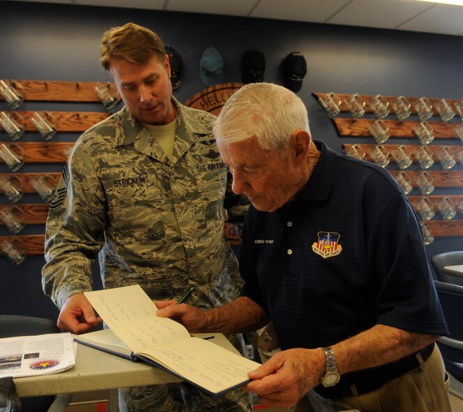 Former Chief Master Sgt. of the Air Force Robert Gaylor signs the 20th Reconnaissance Squadron’s distinguished visitor guest log book as U.S. Air Force Chief Master Sgt. John Stricklin, 20th RS superintendent, recounts other guests who have visited the squadron, Whiteman Air Force Base, Mo., August 7, 2013. Gaylor, who served as the fifth CMSAF from 1977 to 1979, spoke with Airmen at Whiteman about his time in the military and how to overcome obstacles in their careers. (U.S. Air Force photo by Staff Sgt. Alexandra M. Boutte/Released)