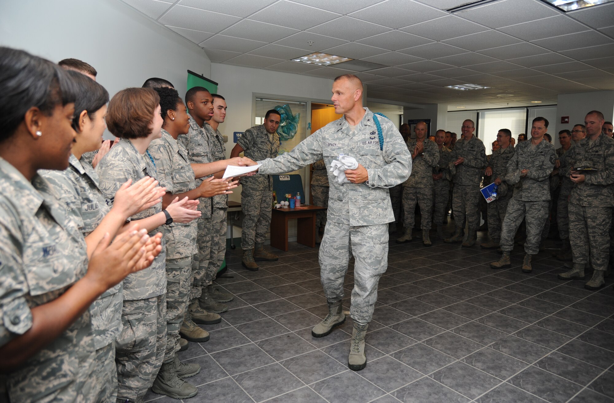 Brig. Gen. Brad Spacy, 81st Training Wing commander, thanks Teal Rope Airmen during a presentation making Spacy an honorary 81st TRW Teal Rope member Aug. 15, 2013, at Dolan Hall, Keesler Air Force Base, Miss. Spacy was presented with a teal rope and a Keesler Sexual Assault Prevention and Response T-shirt.  (U.S. Air Force photo by Kemberly Groue)
