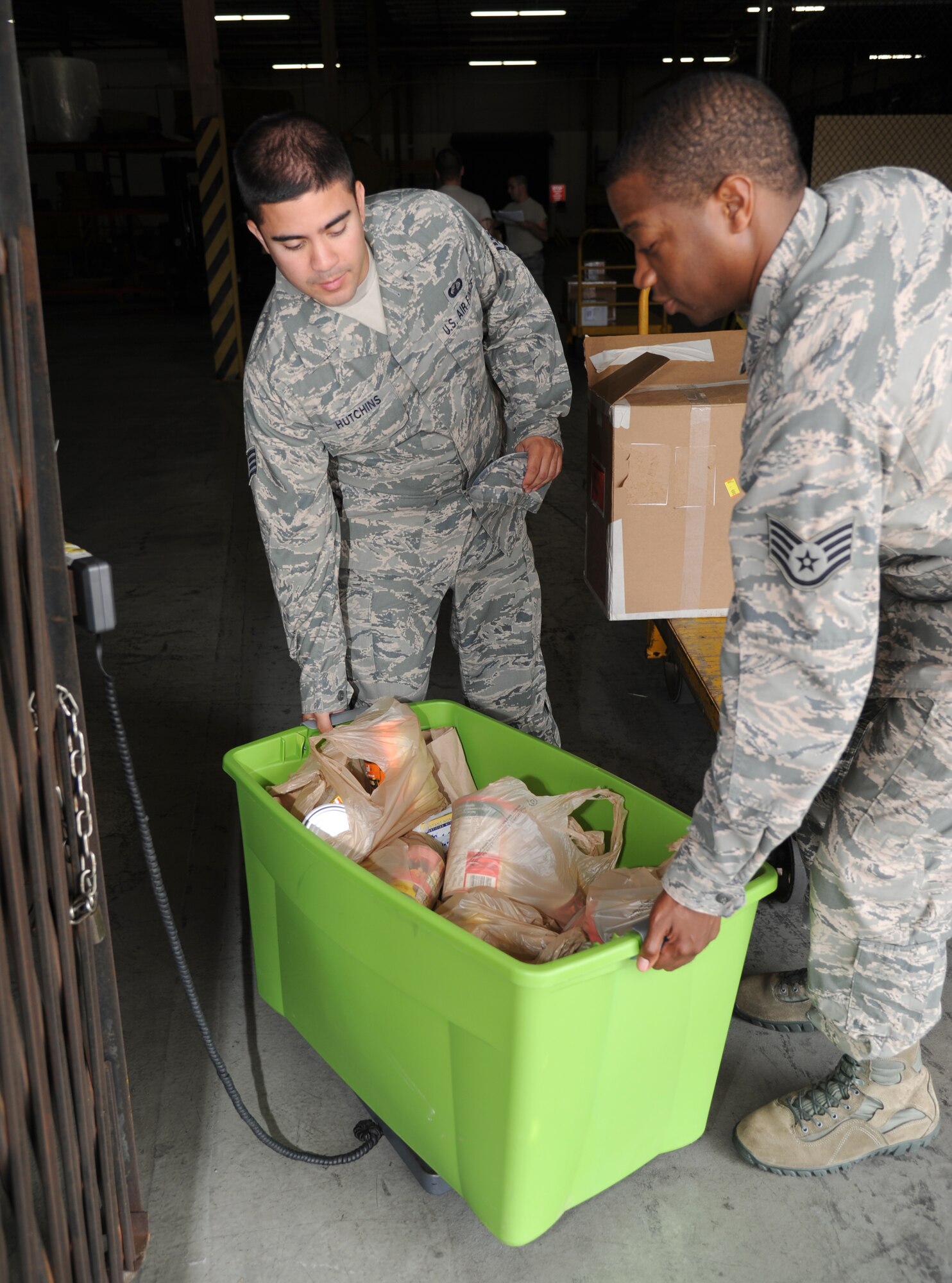 Staff Sgts. Thomas Hutchins and Justin Cheeks, 81st Contracting Squadron, weigh a tub of donated food items collected in the squadron for Keesler’s Feds Feed Families Campaign Aug. 15, 2013, at the Taylor Logistics Center loading dock, Keesler Air Force Base, Miss. The campaign will continue thru Aug. 31 and all donations will be delivered to Back Bay Mission in Biloxi, Miss., Sept. 2.  (U.S. Air Force photo by Kemberly Groue)