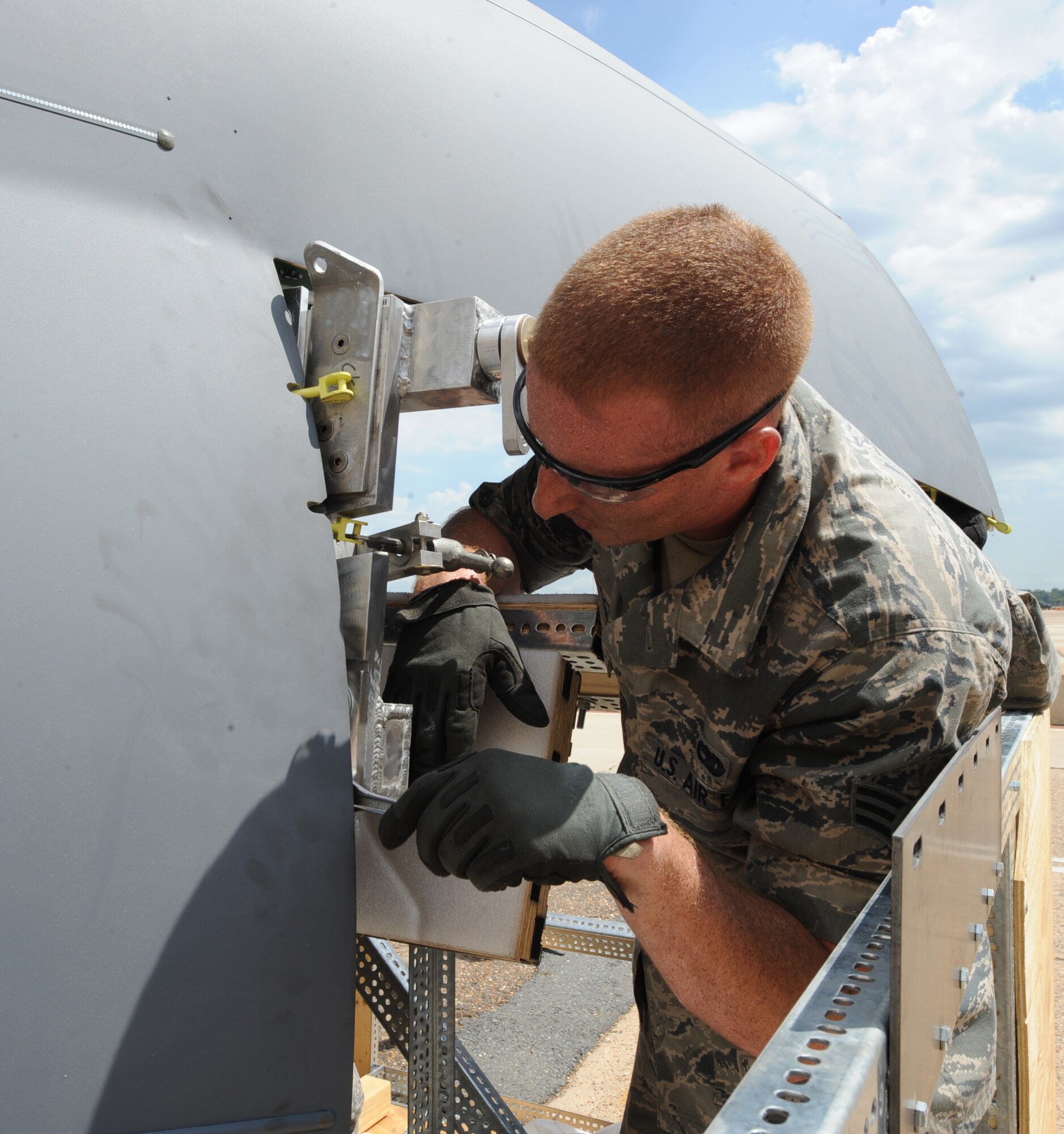 Senior Airman Dylan Drake, 2nd Aircraft Maintenance Squadron crew chief, secures a bolt to a B-52H Stratofortress radome on Barksdale Air Force Base, La., Aug. 13, 2013. Airmen from the 2nd Maintenance Squadron fabrication flight modified the sling to fit on older nose pieces. (U.S. Air Force photo/Senior Airman Sean Martin)
