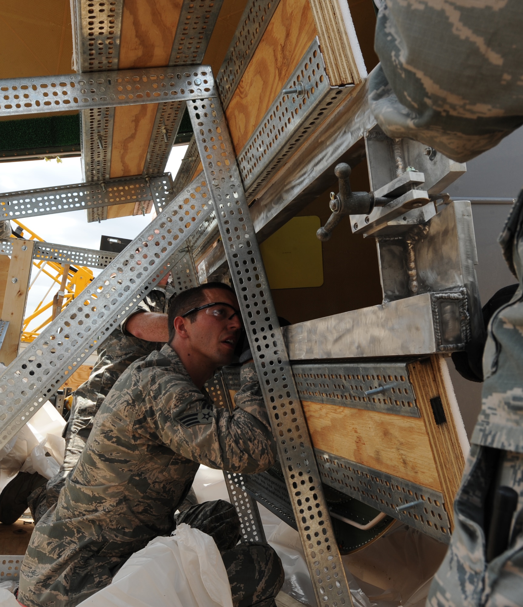 Senior Airman Jacob Andrews, 2nd Aircraft Maintenance Squadron crew chief, attaches a sling to a B-52H Stratofortress radome on Barksdale Air Force Base, La., Aug. 13, 2013. The sling was created by Airmen from the 2nd Maintenance Squadron fabrication flight to help reduce safety hazards and cut back on manpower needed to transport and attach a radome on a B-52H. (U.S. Air Force photo/Senior Airman Sean Martin)
