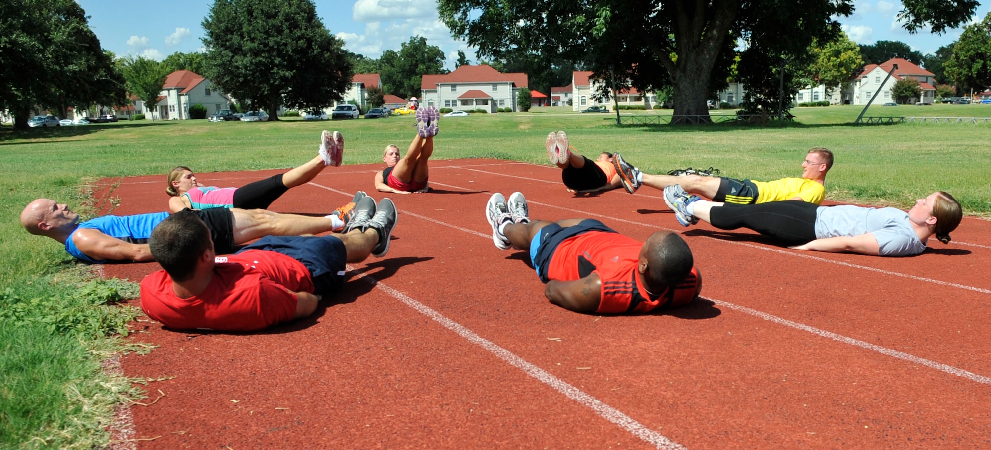 Airmen perform calisthenics during a class as part of the BE-WELL program on Barksdale Air Force Base, Aug. 12, 2013. BE-WELL is acronymic for "Balanced Eating, Working out Effectively; Live a long, healthy and productive Life," and was designed to replace the Healthy Living Program. (U.S. Air Force photo/Airman 1st Class Benjamin Raughton) 