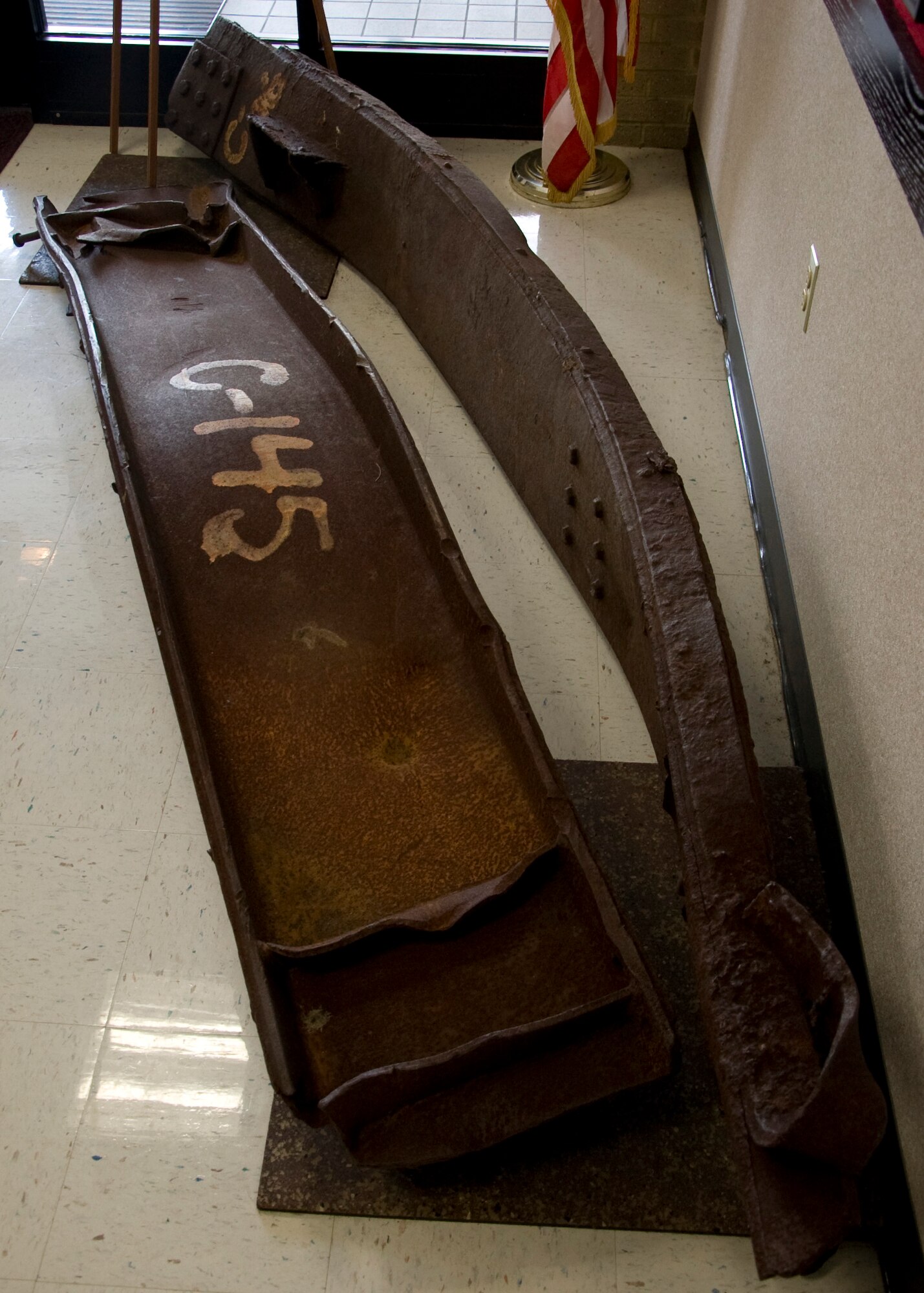 Two steel beams from the World Trade Center, Tower One, sit at the 436th Civil Engineer Squadron Fire Department on Dover Air Force Base, Del., Aug. 15, 2013, before they are set to be incorporated into a 9/11 memorial. The memorial will be located at the Air Mobility Command museum on Dover AFB and will be Delaware’s first memorial to incorporate steel beams from the towers.(U.S. Air Force photo/Senior Airman Jared Duhon)