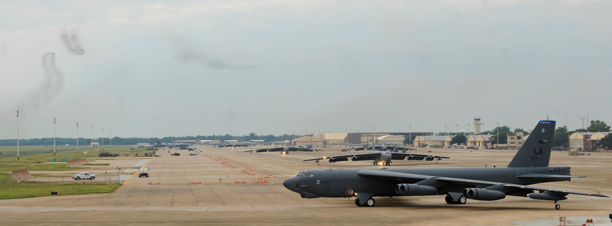 B-52H Stratofortress bombers taxi on the flightline during a minimum interval take-off on Barksdale Air Force Base, La., Aug. 15, 2013. During a MITO, starter carts filled with gunpowder are used to quickly fire the bomber?s engines for take-off. The B-52 is capable of carrying nuclear or precision guided conventional ordnance with worldwide precision navigation capability. (U.S. Air Force photo/Airman 1st Class Andrew Moua)