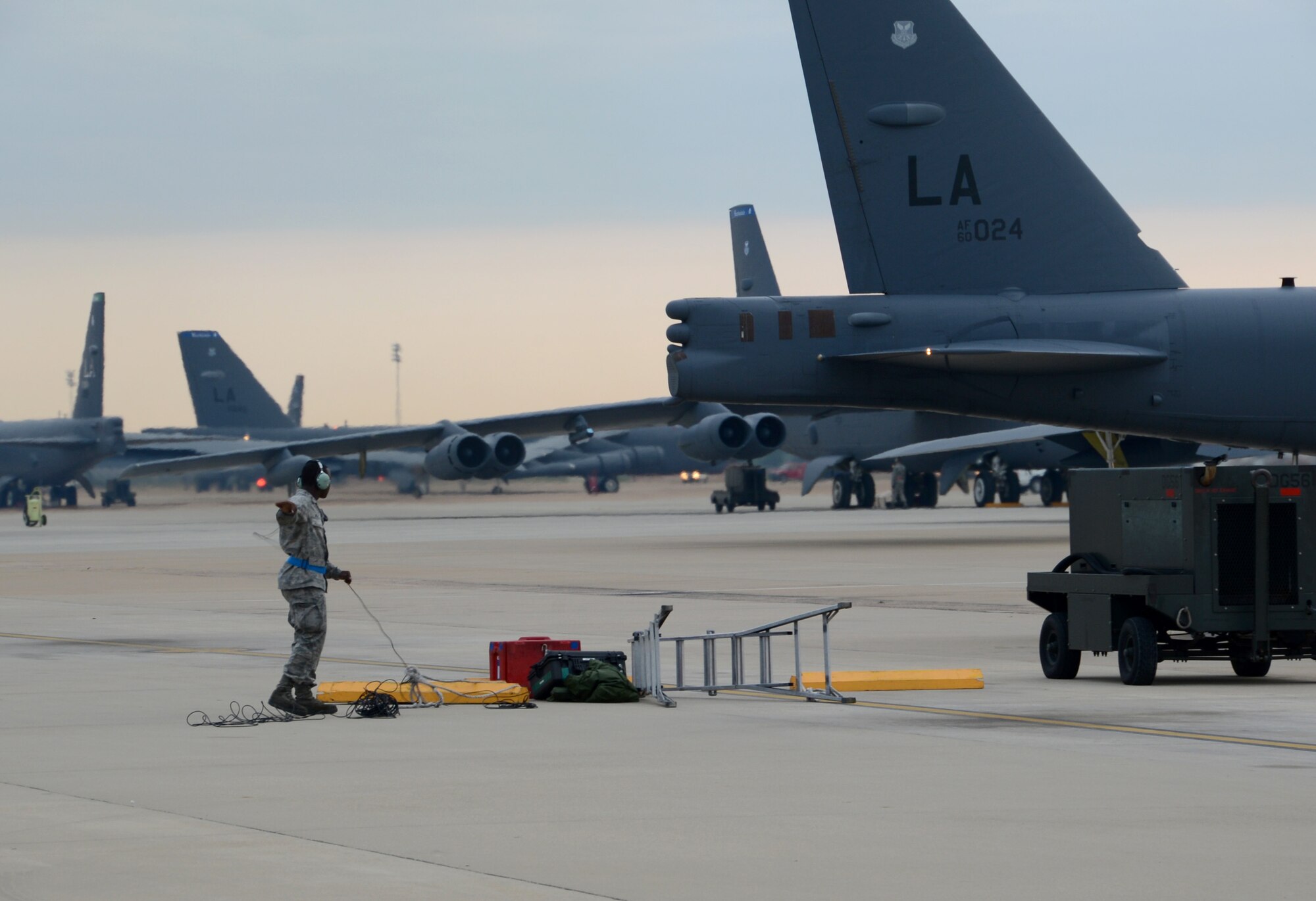Airman 1st Class Jamichael Wiley, 20th Aircraft Maintenance Unit crew chief, stands by after assisting with the launch of a B-52H Stratofortress on the flightline at Barksdale Air Force Base, La., Aug. 15, 2013. During a simulated alert, aircrews rushed to their B-52s and used starter cartridges filled with gun powder to quickly fire the bomber?s engines and taxi for takeoff. (U.S. Air Force photo/Staff Sgt. Amber Corcoran)