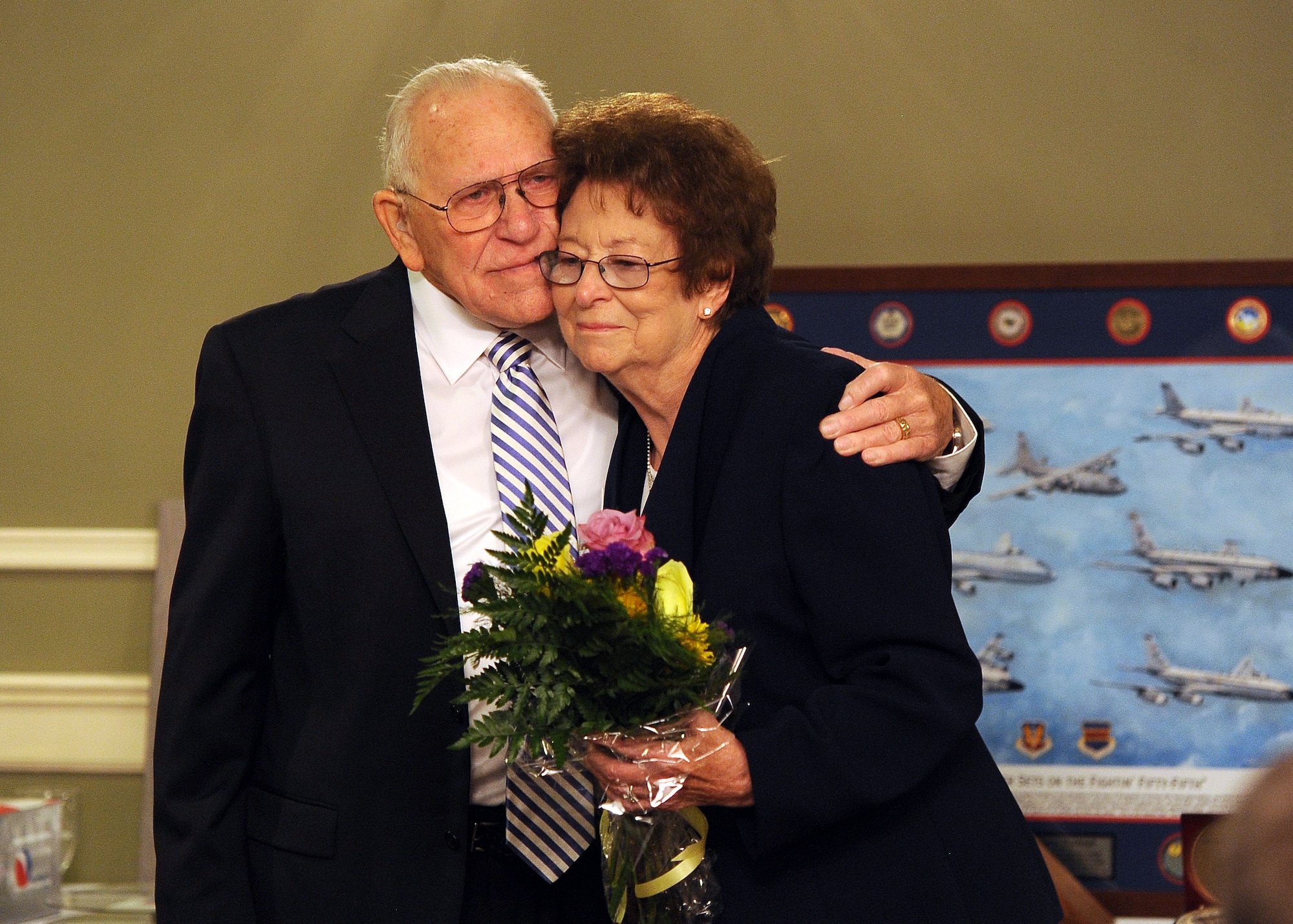 James Norwood, an electronic intelligence advisor with the National Security Agency’s representative office at United States Strategic Command, embraces his wife Jean while saying his farewell at his retirement ceremony held at the Patriot Club July 31 on Offutt Air Force Base, Neb.  Jean has been alongside her husband for 59 years of his nearly 60 years of federal service.  (U.S. Air Force photo by Josh Plueger/Released)