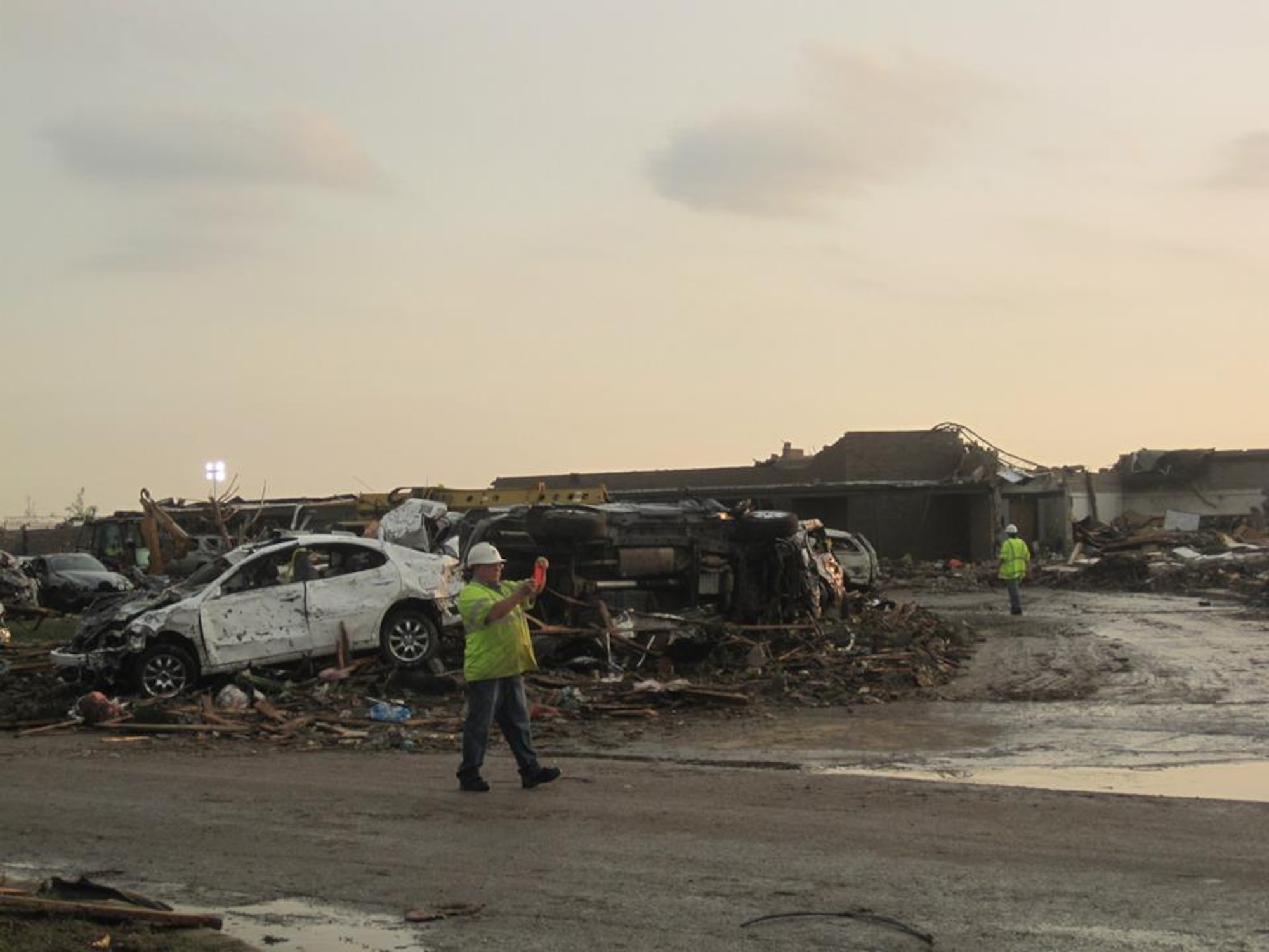 Workers survey the site of a school leveled by a massive 1.3-mile-wide tornado that touched down in Moore, Okla., May 20. (U.S. Air Force photo/Staff Sgt. Brandi Smith)