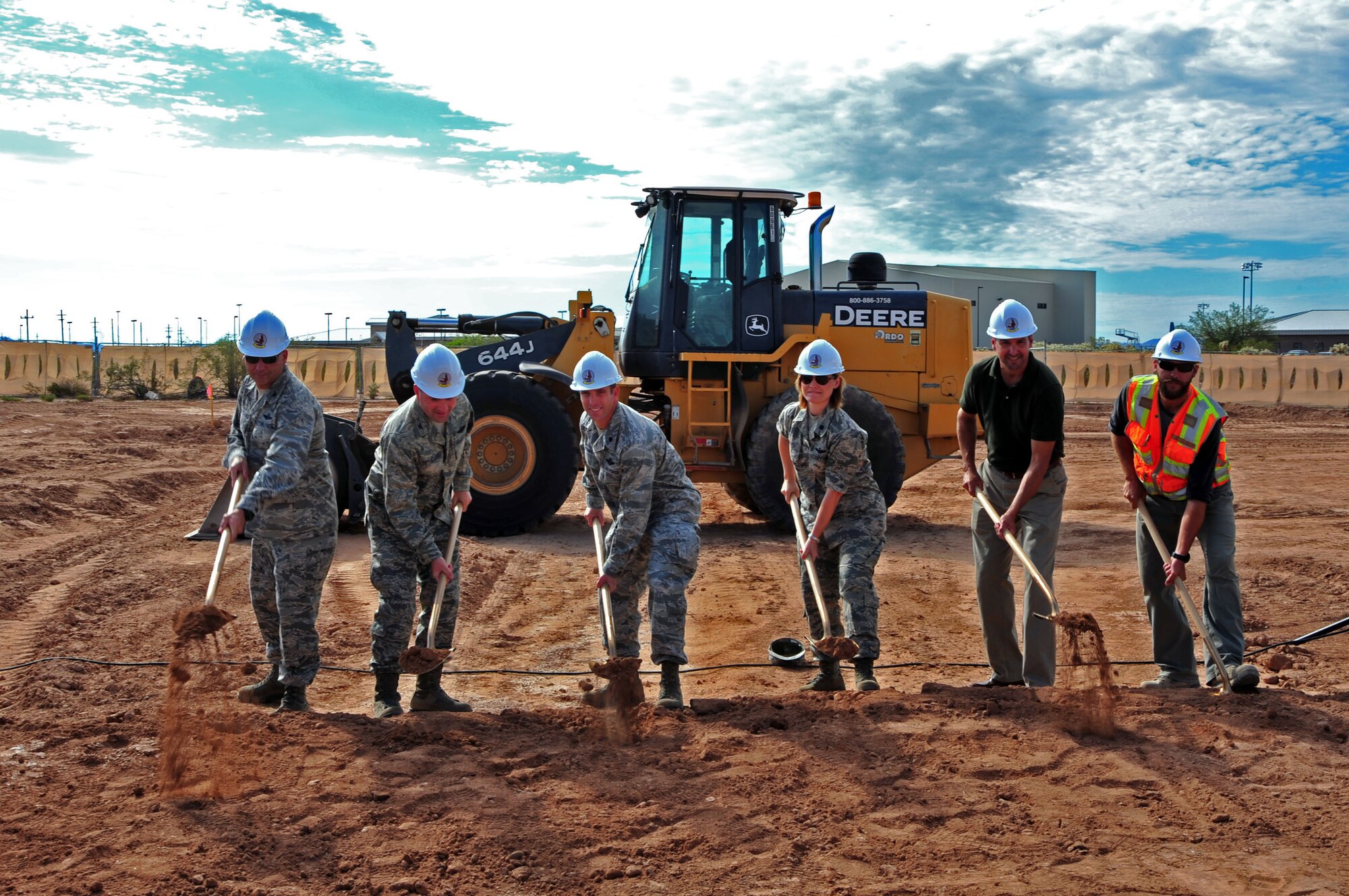 Desert Lightning Team commanders and contractors break ground at Davis-Monthan Air Force Base, Ariz., Aug. 15, 2013. From left; Col. Kevin Blanchard, 355th Fighter Wing commander; Col. Marty Reynolds, 55th Electronic Combat Group commander; Lt. Col. Phil Acquaro, 42nd Electronic Combat Squadron commander; Lt Col. Angela Spaith, 755th Operational Support Squadron commander; Anthony Gomez, 355th Civil Engineer Squadron lead architect; and Andrew Erquiaga, RSCI Group construction team lead.